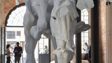 A girl encounters a giant white horse frozen in mid-air within the venice biennale’s Argentinian pavilion