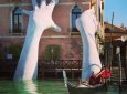 Giant hands rise from a canal in Venice to send a powerful message about climate change