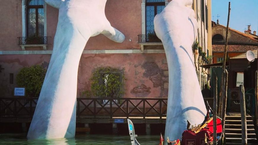 Giant hands rise from a canal in Venice to send a powerful message about climate change